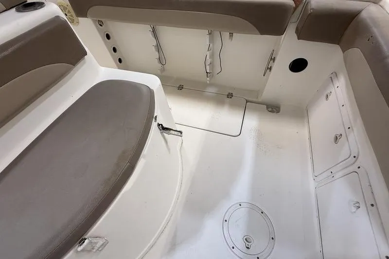 Slide: The Image of 2000 Pro-Line 23 Sport boat interior with cushioned seating and storage compartments. - 7