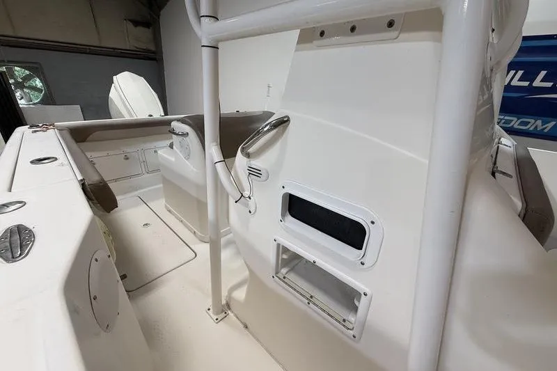 Slide: The Image of 2000 Pro-Line 23 Sport boat interior, featuring white seating and storage compartments. - 14