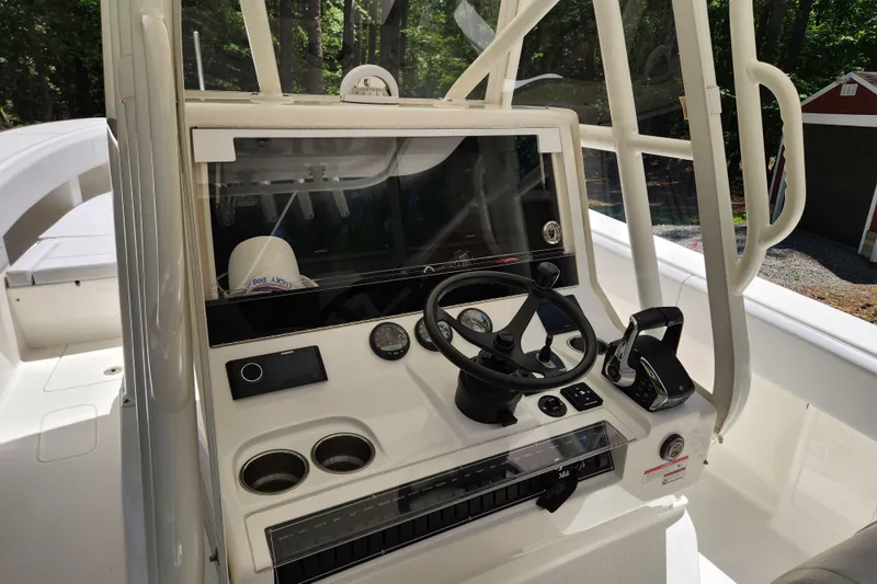 Slide: The Image of 2024 SeaVee 322Z boat console with steering wheel, controls, and gauges in a sleek design. - 6