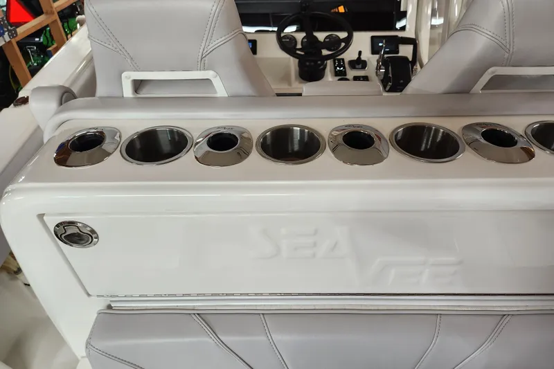 Slide: The Image of 2024 SeaVee 322Z boat interior with cup holders and steering wheel. - 13