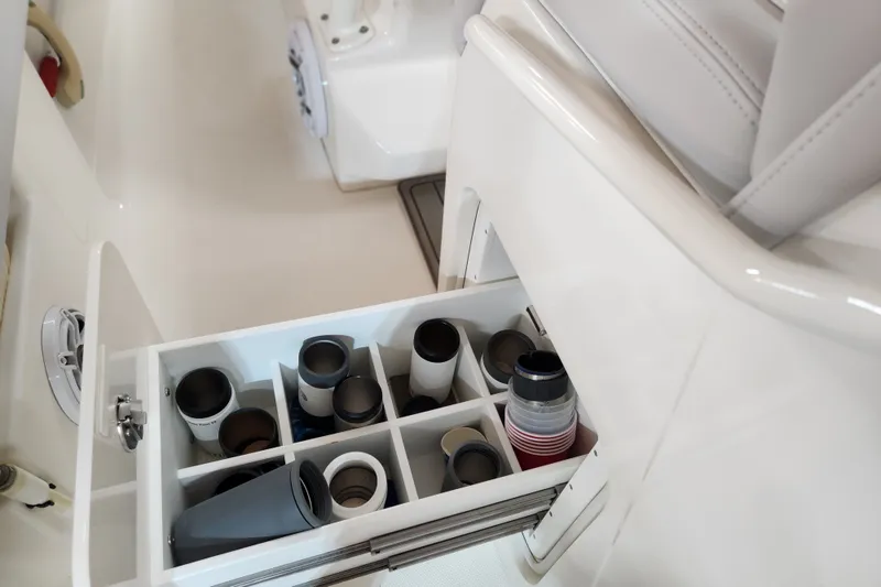Slide: The Image of 2024 SeaVee 322Z boat storage compartment with organized cup holders and accessories. - 15