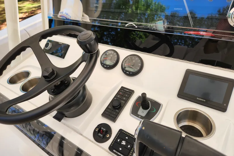 Slide: The Image of 2024 SeaVee 322Z boat dashboard with steering wheel, gauges, and Garmin display. - 7