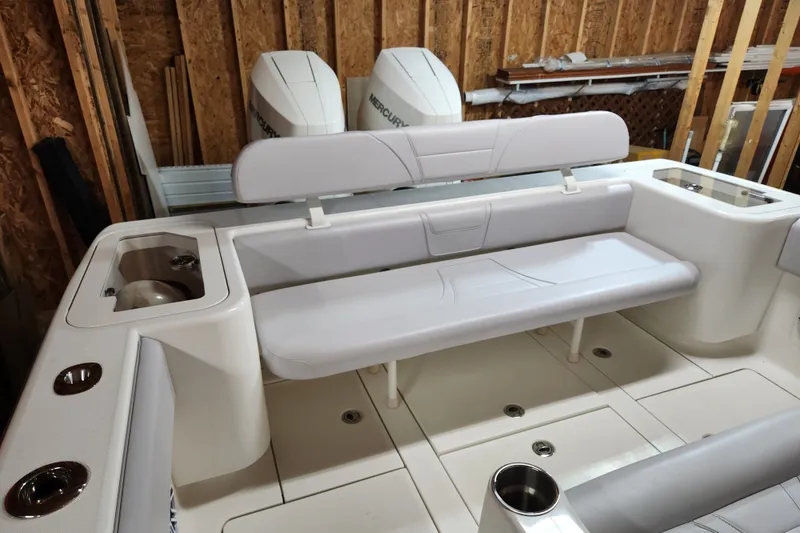 Slide: The Image of 2024 SeaVee 322Z boat interior with seating and Mercury engines in a wooden garage. - 11