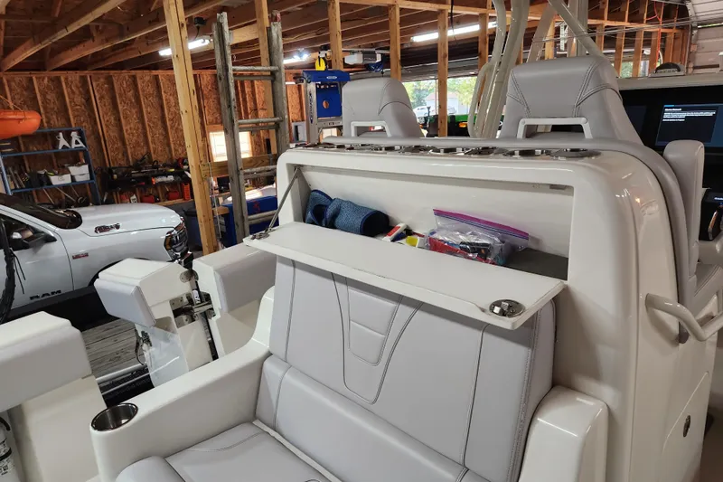 Slide: The Image of 2024 SeaVee 322Z boat interior with storage compartment open in a garage setting. - 12