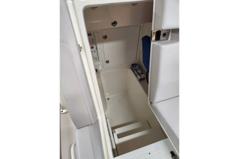 Slide: The Image of 2024 SeaVee 322Z boat interior storage compartment with white cushioned seating. - 5