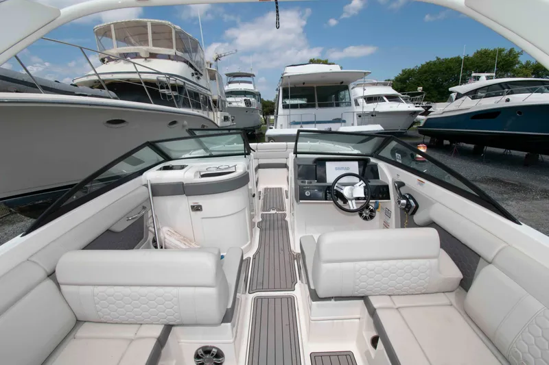 Slide: The Image of 2024 Sea Ray SDX 270 Outboard boat interior with luxurious seating and modern dashboard. - 3