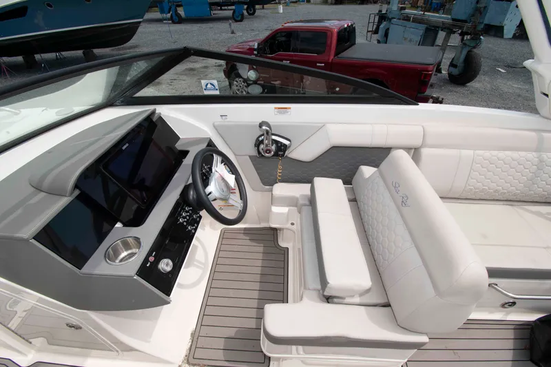 Slide: The Image of 2024 Sea Ray SDX 270 Outboard boat interior with modern helm and luxurious seating. - 4