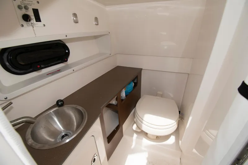 Slide: The Image of 2024 Sea Ray SDX 270 Outboard boat bathroom with sink and toilet. - 9
