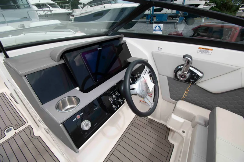 Slide: The Image of 2024 Sea Ray SDX 270 Outboard helm with modern controls and sleek design. - 5
