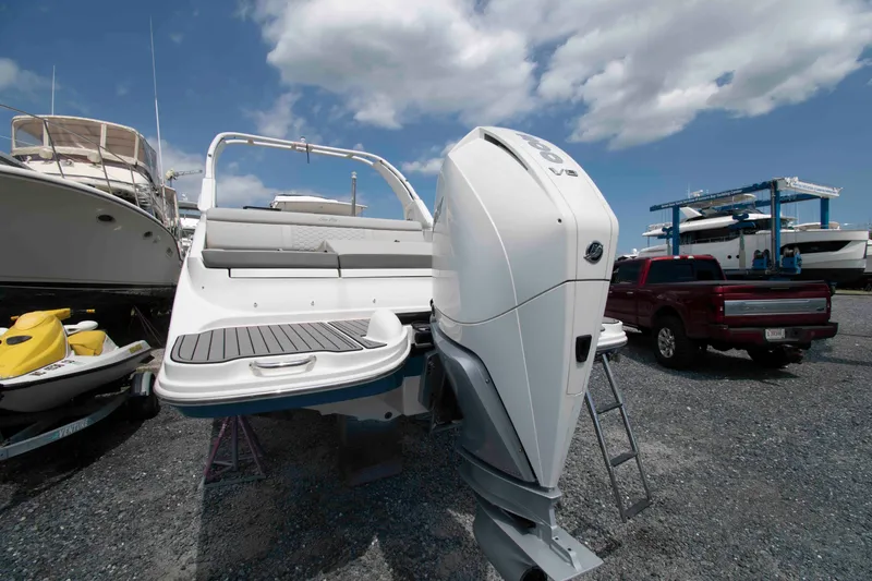 Slide: The Image of 2024 Sea Ray SDX 270 Outboard boat with powerful engine, parked in a marina under a cloudy sky. - 10