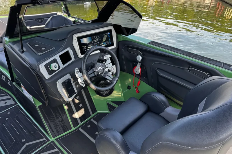 Slide: The Image of Interior of 2026 Centurion Nv243 boat with modern dashboard and steering wheel. - 19