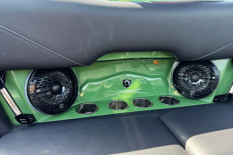 Slide: The Image of Interior of 2026 Centurion Nv243 with green panel, speakers, and cup holders. - 23