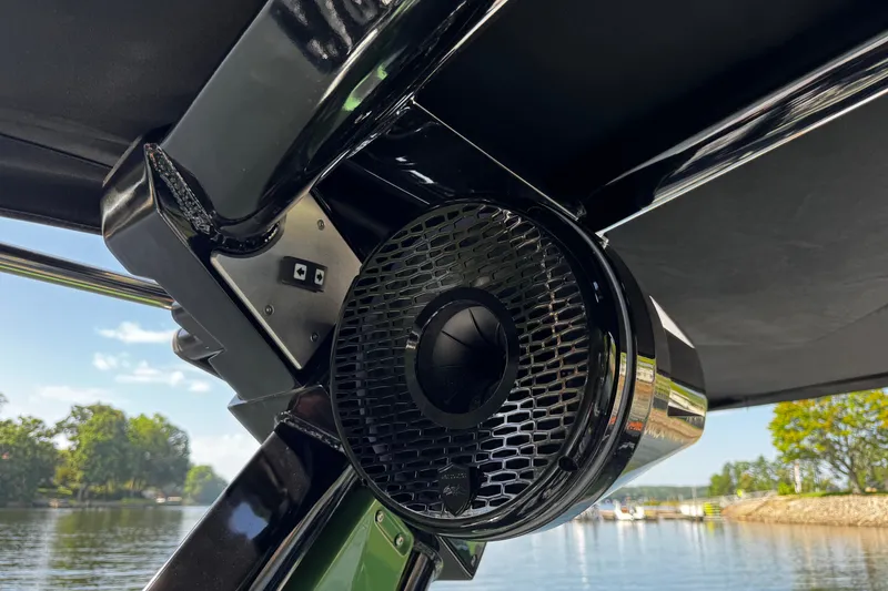 Slide: The Image of Close-up of a Centurion Nv243 boat speaker, 2026 model, with scenic water background. - 22