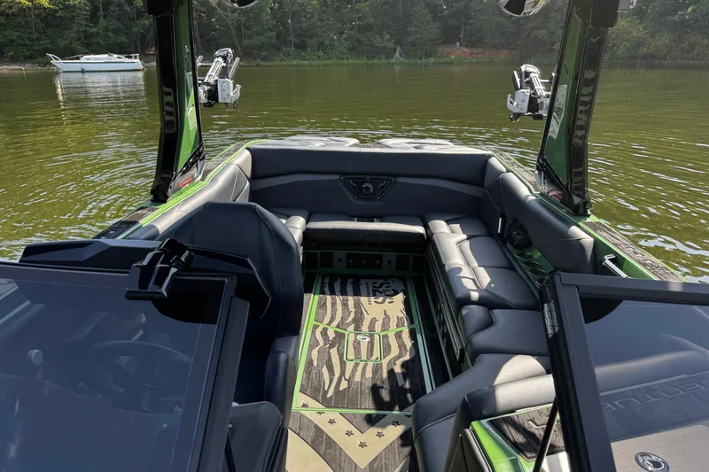 Slide: The Image of Interior of 2026 Centurion Nv243 boat with luxurious seating on a calm lake. - 24