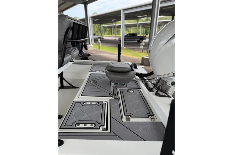 Slide: The Image of Avid 21 Mag 2027 boat interior with sleek gray deck and seating. - 19