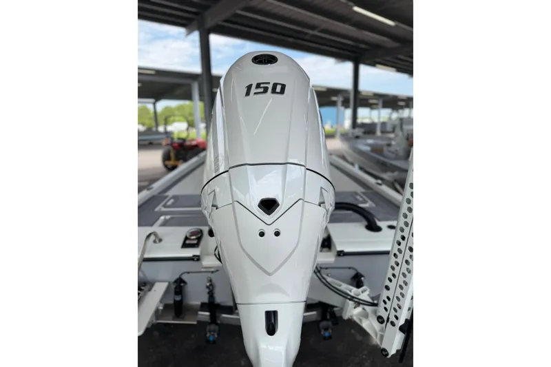 Slide: The Image of Avid 21 Mag 2027 boat engine, 150 horsepower, in a covered marina setting. - 15