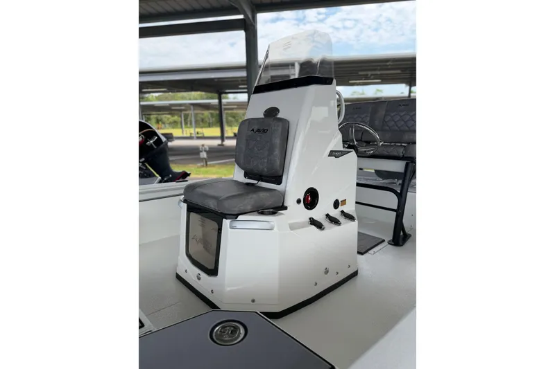 Slide: The Image of Avid 21 Mag 2027 boat console with cushioned seat and steering wheel. - 22