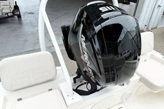Slide: The Image of 2027 Boston Whaler 150 Montauk boat with Mercury outboard motor, white seating, and sleek design. - 13