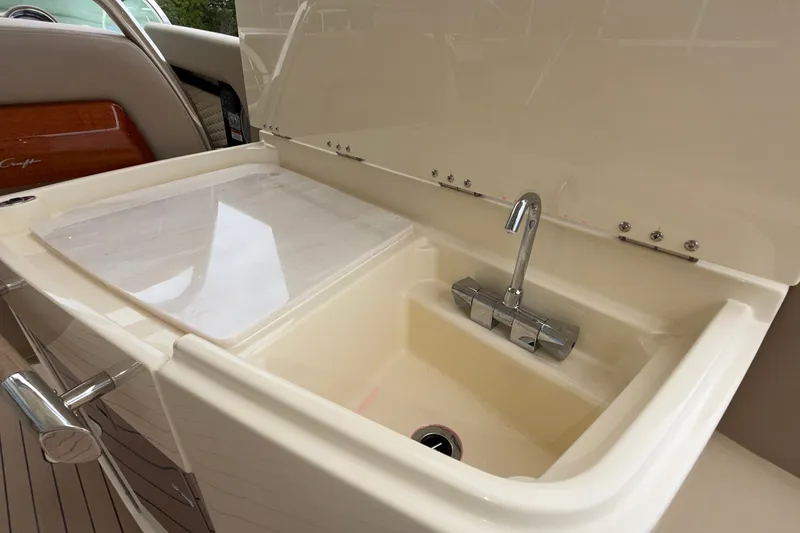 Slide: The Image of Luxury sink on 2027 Chris-Craft Launch 35 GT boat, featuring sleek design and chrome faucet. - 35