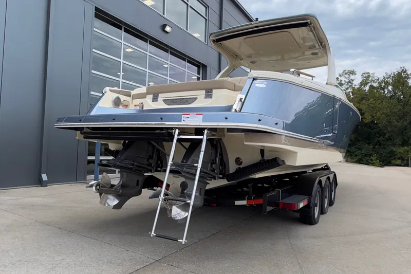 Slide: The Image of 2027 Chris-Craft Launch 35 GT boat on trailer, rear view, parked outdoors. - 8