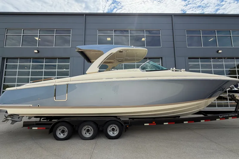 Slide: The Image of 2027 Chris-Craft Launch 35 GT boat on trailer, parked outside modern building. - 5