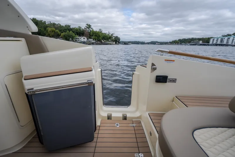Slide: The Image of 2027 Chris-Craft Launch 35 GT boat interior with lake view, featuring elegant seating and deck. - 24