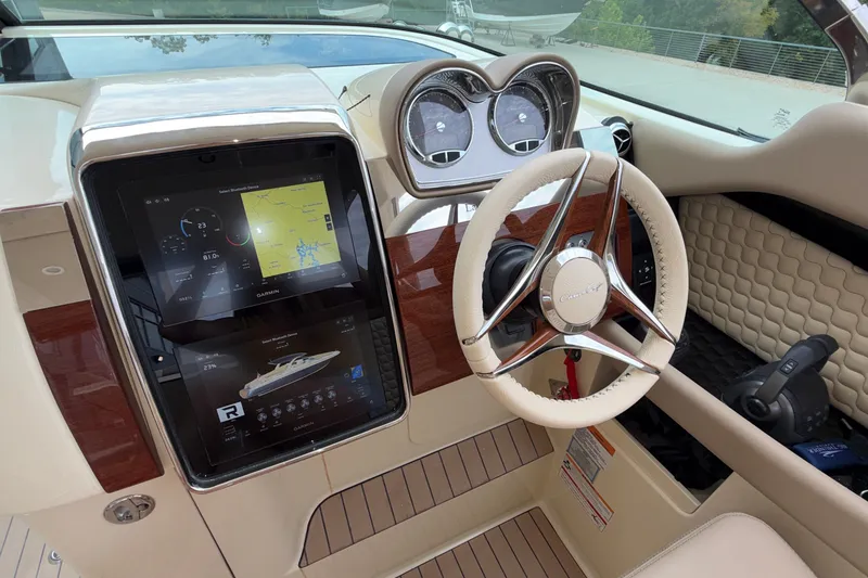 Slide: The Image of 2027 Chris-Craft Launch 35 GT dashboard with steering wheel and navigation display. - 60