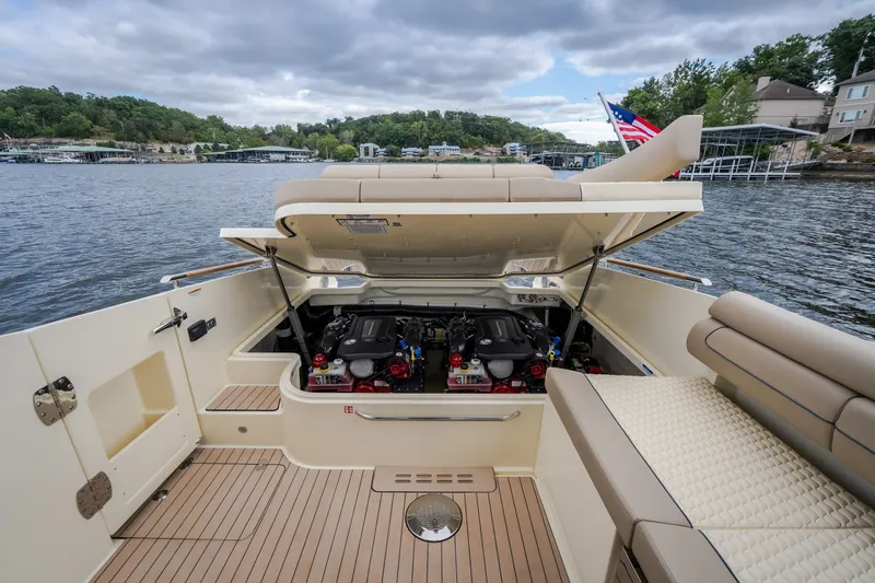 Slide: The Image of 2027 Chris-Craft Launch 35 GT boat with open engine compartment on a scenic lake. - 31
