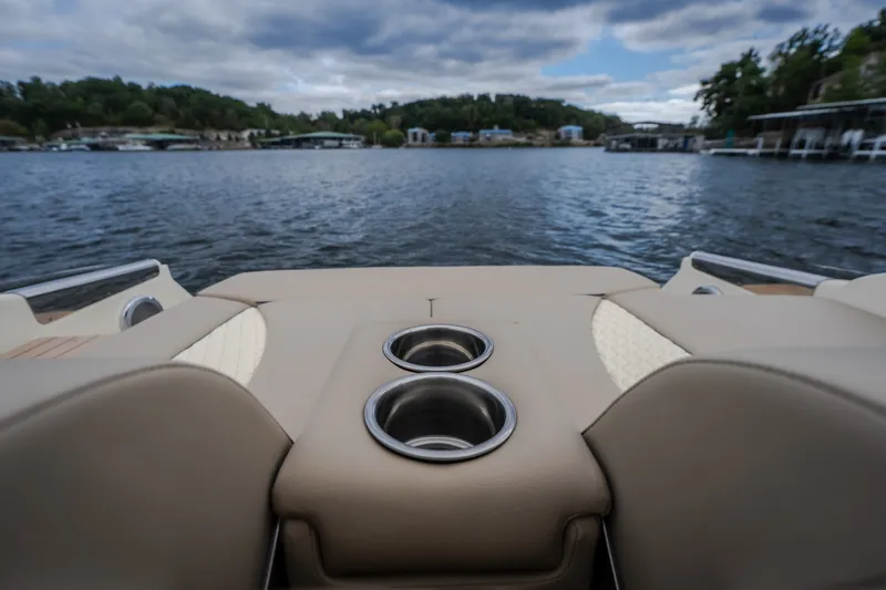 Slide: The Image of 2027 Chris-Craft Launch 35 GT boat interior with cup holders, overlooking a serene lake. - 23