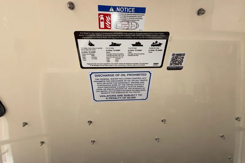 Slide: The Image of Warning labels on Chris-Craft Launch 35 GT, 2027 model, prohibiting waste discharge. - 74