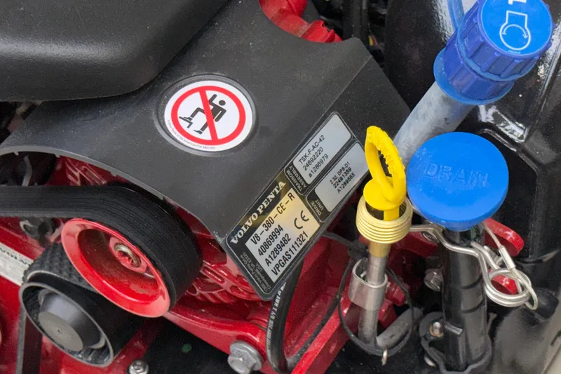 Slide: The Image of Close-up of a 2027 Chris-Craft Launch 35 GT engine components with labels and warning signs. - 70