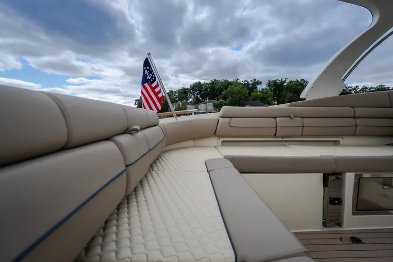 Slide: The Image of Luxurious seating on 2027 Chris-Craft Launch 35 GT boat with American flag and cloudy sky. - 27