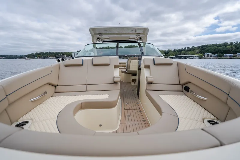 Slide: The Image of 2027 Chris-Craft Launch 35 GT boat interior with luxurious seating on a calm lake. - 77