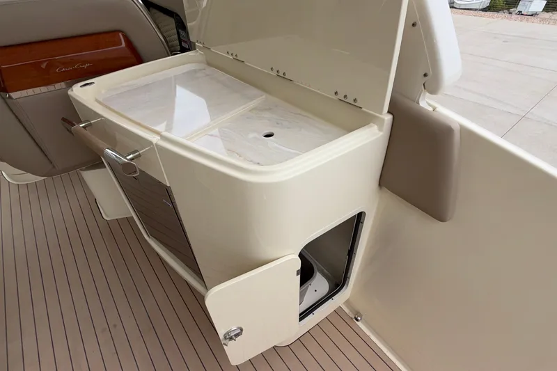 Slide: The Image of 2027 Chris-Craft Launch 35 GT interior with open storage compartment and sleek design. - 33