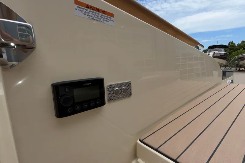 Slide: The Image of 2027 Chris-Craft Launch 35 GT boat with control panel and warning label. - 27