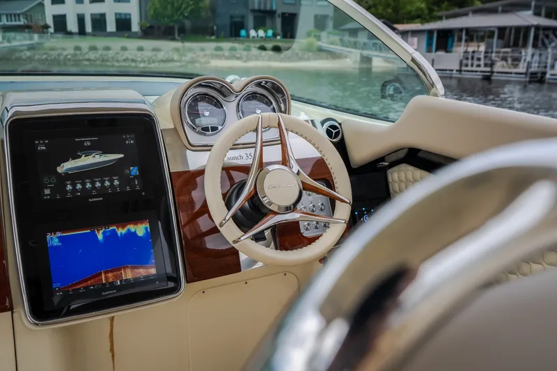 Slide: The Image of Interior view of 2027 Chris-Craft Launch 35 GT dashboard with steering wheel and digital displays. - 49