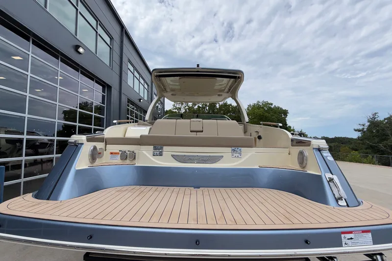 Slide: The Image of 2027 Chris-Craft Launch 35 GT boat with sleek design, docked near modern building. - 9