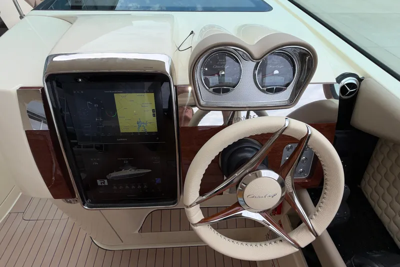 Slide: The Image of 2027 Chris-Craft Launch 35 GT dashboard with steering wheel and navigation display. - 64