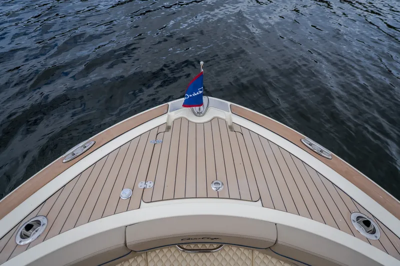 Slide: The Image of 2027 Chris-Craft Launch 35 GT boat deck with flag, on calm water. - 75