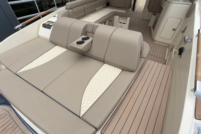 Slide: The Image of Luxurious seating on 2027 Chris-Craft Launch 35 GT boat with beige upholstery and cup holders. - 16