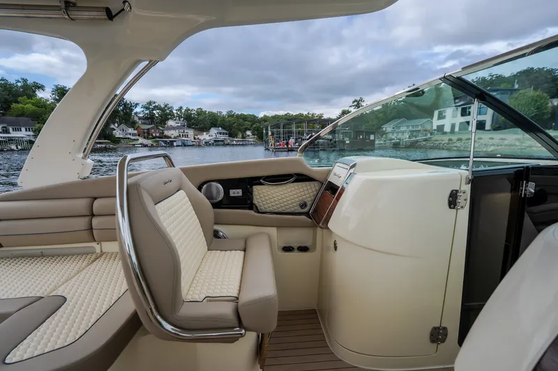 Slide: The Image of 2027 Chris-Craft Launch 35 GT interior with luxurious seating and scenic waterfront view. - 62