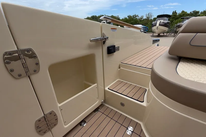 Slide: The Image of 2027 Chris-Craft Launch 35 GT boat interior with beige seating and wooden flooring. - 17