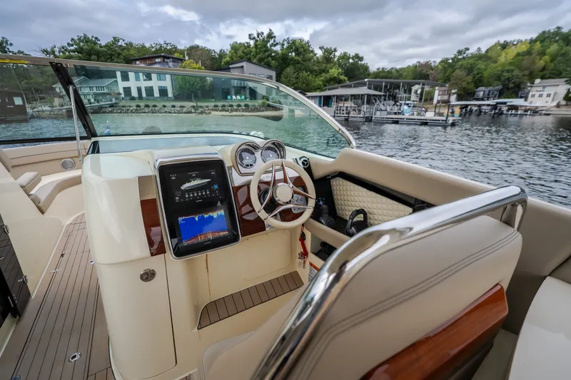 Slide: The Image of 2027 Chris-Craft Launch 35 GT boat interior with modern dashboard and steering wheel. - 48