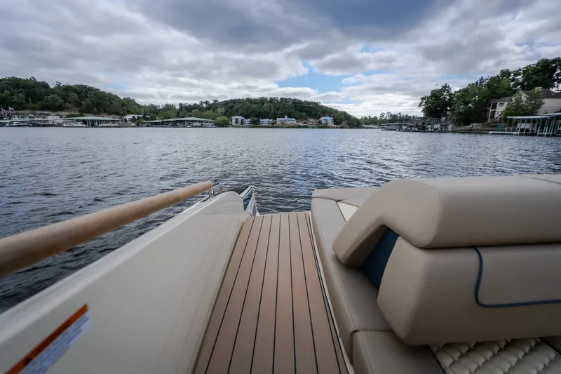 Slide: The Image of 2027 Chris-Craft Launch 35 GT boat on a scenic lake with cloudy sky. - 29