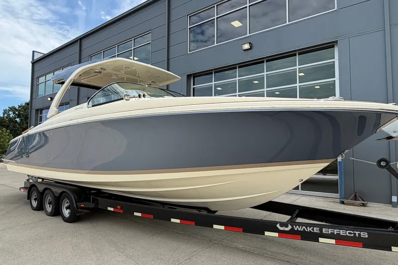 Slide: The Image of 2027 Chris-Craft Launch 35 GT boat on trailer, parked outside modern building. - 4