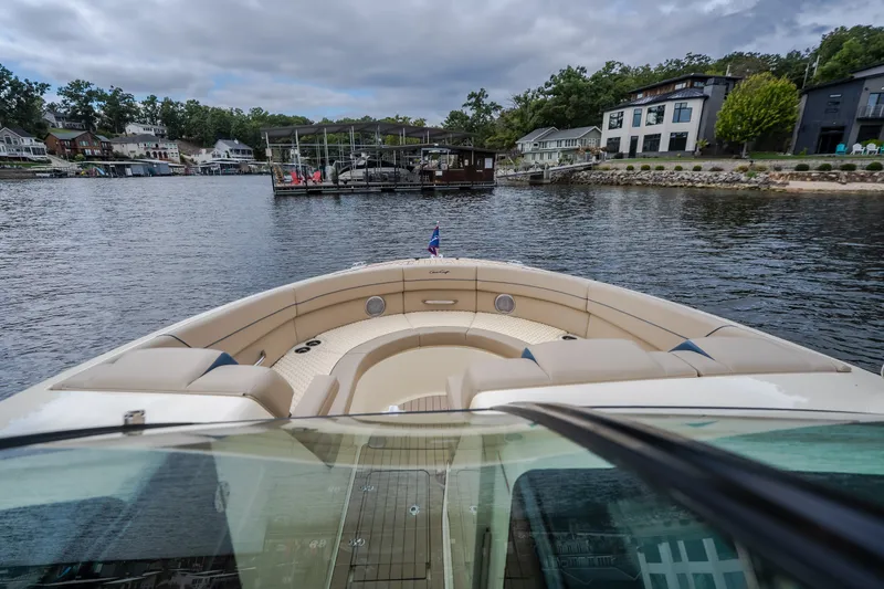 Slide: The Image of 2027 Chris-Craft Launch 35 GT boat on a scenic lake with waterfront homes. - 69