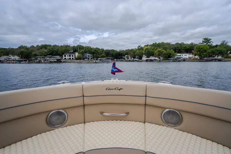 Slide: The Image of 2027 Chris-Craft Launch 35 GT boat on a lake with shoreline view. - 72