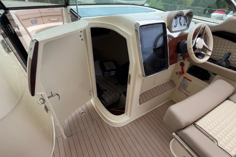 Slide: The Image of 2027 Chris-Craft Launch 35 GT interior with open cabin door and steering wheel. - 46