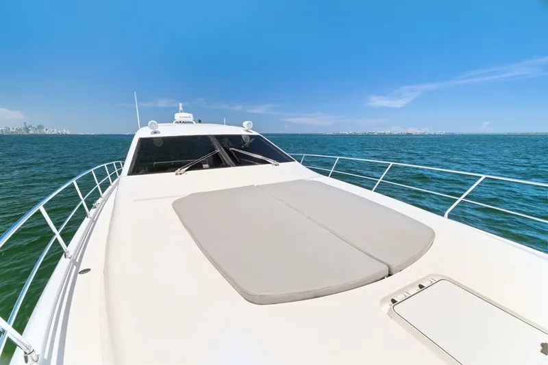 Slide: The Image of 2005 Uniesse 54 Sport yacht cruising on open water under clear blue skies. - 28
