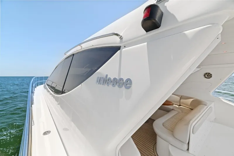 Slide: The Image of 2005 Uniesse 54 Sport yacht on open water, showcasing sleek design and luxury interior. - 27